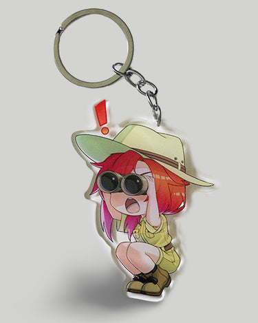 Keychain with an anime-style character wearing a hat and sunglasses on a light gray background