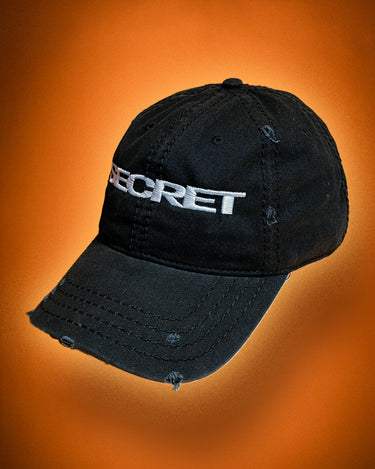 Black cap with 'SECRET' text on an orange background