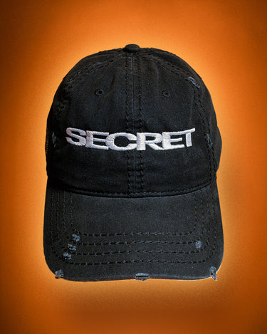 Black cap with 'SECRET' embroidered on an orange background
