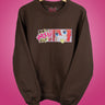 Brown sweatshirt with cute anime character eating a potato chip graphic on a pink background